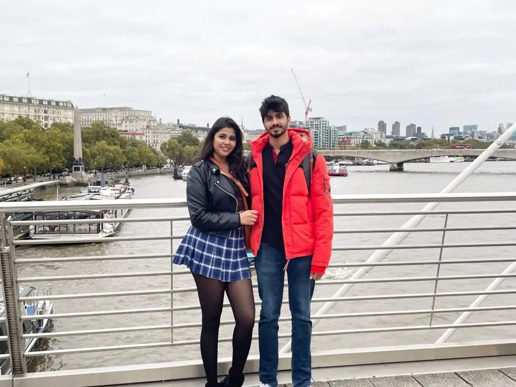 Chaitra and Parth standing on a bridge over water